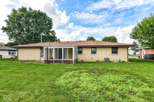 823 Rustic Rd, Anderson, IN 46013 - rear view of property with brick siding, a sunroom, a chimney, and crawl space