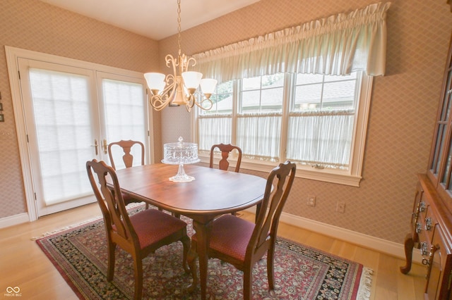 1870 Broadleaf Ct Unit 10, Greenwood, IN 46143 - dining area with wallpapered walls, light wood finished floors, plenty of natural light, and a chandelier