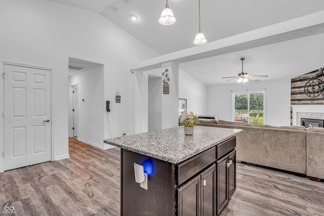 1181 S Aberdeen Dr, Franklin, IN 46131 - kitchen featuring light wood-style flooring, dark brown cabinetry, ceiling fan, open floor plan, and decorative light fixtures