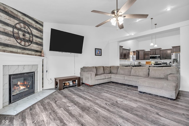 1181 S Aberdeen Dr, Franklin, IN 46131 - living area with ceiling fan, lofted ceiling, a fireplace, and light wood finished floors