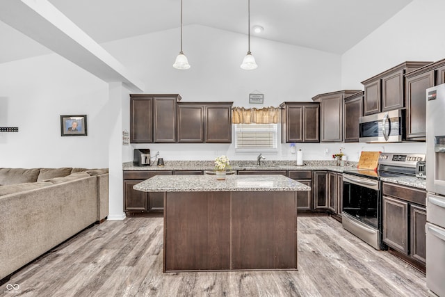 1181 S Aberdeen Dr, Franklin, IN 46131 - kitchen with stainless steel appliances, high vaulted ceiling, open floor plan, dark brown cabinetry, and a kitchen island