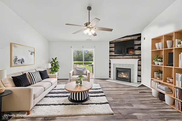 1181 S Aberdeen Dr, Franklin, IN 46131 - living area featuring lofted ceiling, ceiling fan, a tiled fireplace, and wood finished floors