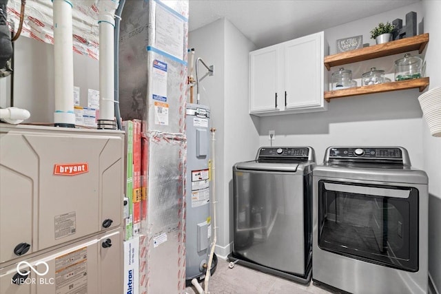 8547 Winton Pl, Pendleton, IN 46064 - laundry area featuring cabinet space, separate washer and dryer, electric water heater, and heating unit