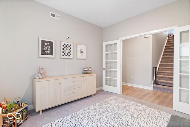 8547 Winton Pl, Pendleton, IN 46064 - sitting room with french doors, stairs, and light colored carpet