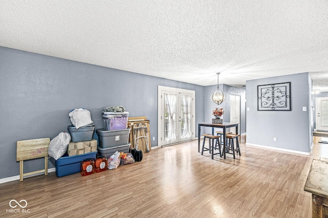 6259 Teacup Dr, Indianapolis, IN 46235 - dining area with a textured ceiling, wood finished floors, and a chandelier