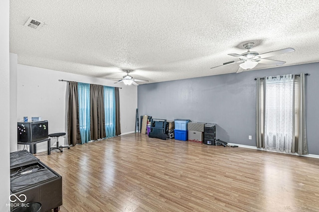 6259 Teacup Dr, Indianapolis, IN 46235 - living area featuring a ceiling fan, wood finished floors, and a textured ceiling