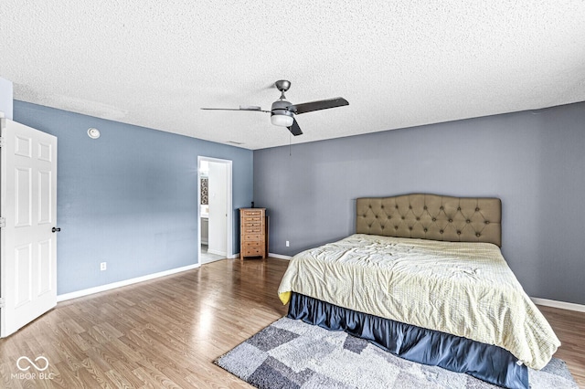 6259 Teacup Dr, Indianapolis, IN 46235 - bedroom with wood finished floors, a textured ceiling, and a ceiling fan