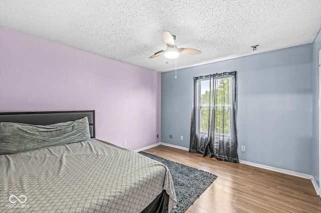 6259 Teacup Dr, Indianapolis, IN 46235 - bedroom featuring wood finished floors, a textured ceiling, and a ceiling fan