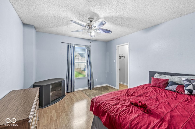 6259 Teacup Dr, Indianapolis, IN 46235 - bedroom with wood finished floors, a textured ceiling, and a ceiling fan