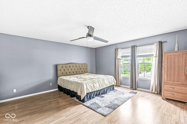 6259 Teacup Dr, Indianapolis, IN 46235 - bedroom with wood finished floors, a textured ceiling, and a ceiling fan