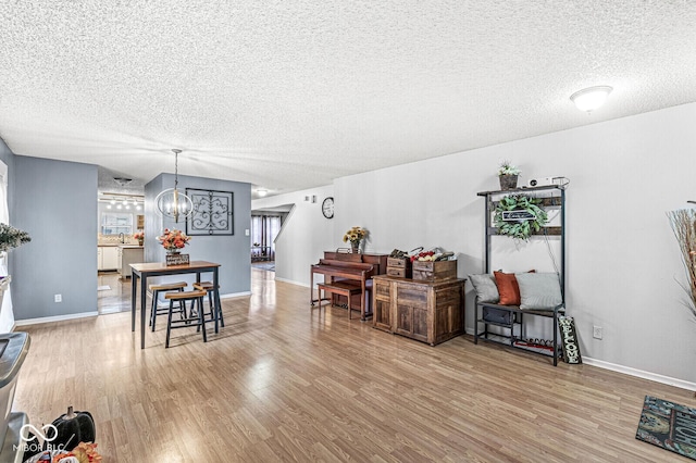 6259 Teacup Dr, Indianapolis, IN 46235 - dining room featuring a textured ceiling, a chandelier, and wood finished floors