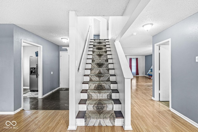 6259 Teacup Dr, Indianapolis, IN 46235 - stairway with a textured ceiling and wood finished floors