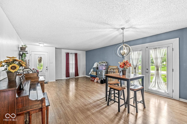6259 Teacup Dr, Indianapolis, IN 46235 - dining space featuring a chandelier, light wood-style flooring, and a textured ceiling