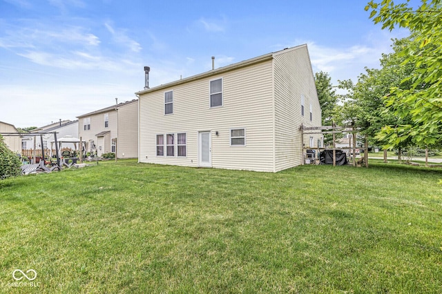 6259 Teacup Dr, Indianapolis, IN 46235 - rear view of property featuring a lawn