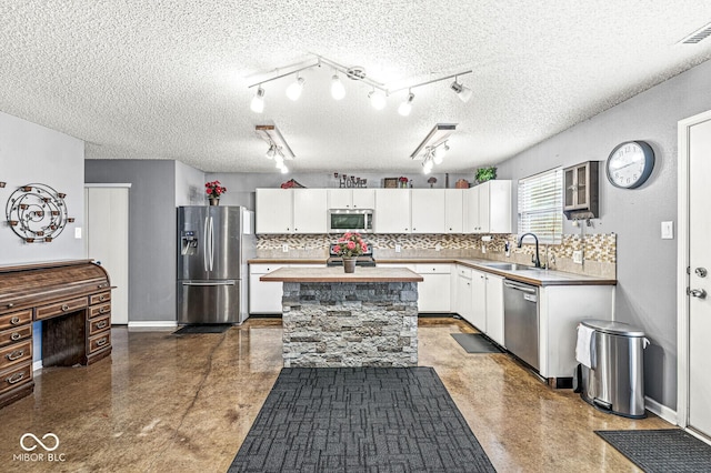 6259 Teacup Dr, Indianapolis, IN 46235 - kitchen featuring stainless steel appliances, white cabinets, a center island, tasteful backsplash, and light countertops
