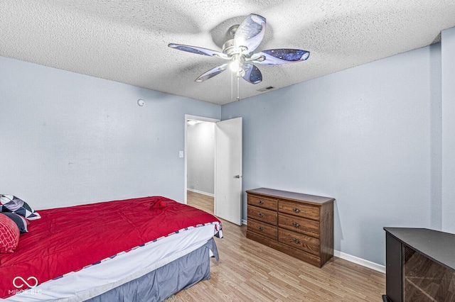 6259 Teacup Dr, Indianapolis, IN 46235 - bedroom with wood finished floors, a ceiling fan, and a textured ceiling