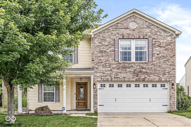 6259 Teacup Dr, Indianapolis, IN 46235 - view of front of home with concrete driveway, an attached garage, and brick siding