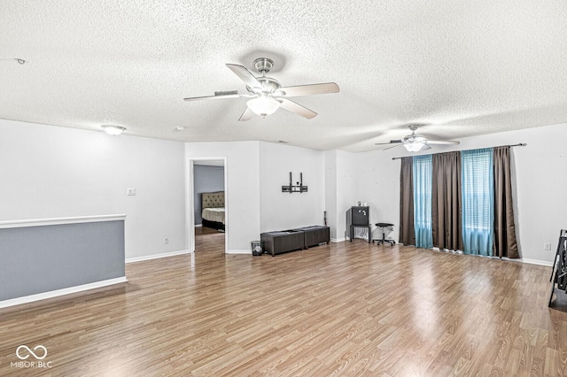 6259 Teacup Dr, Indianapolis, IN 46235 - living area with ceiling fan, a textured ceiling, and light wood-style floors