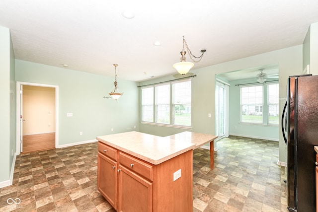 15946 Marsala Dr, Fishers, IN 46037 - kitchen with freestanding refrigerator, light countertops, stone finish flooring, a center island, and hanging light fixtures