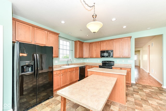15946 Marsala Dr, Fishers, IN 46037 - kitchen featuring black appliances, light countertops, a kitchen island, decorative light fixtures, and recessed lighting