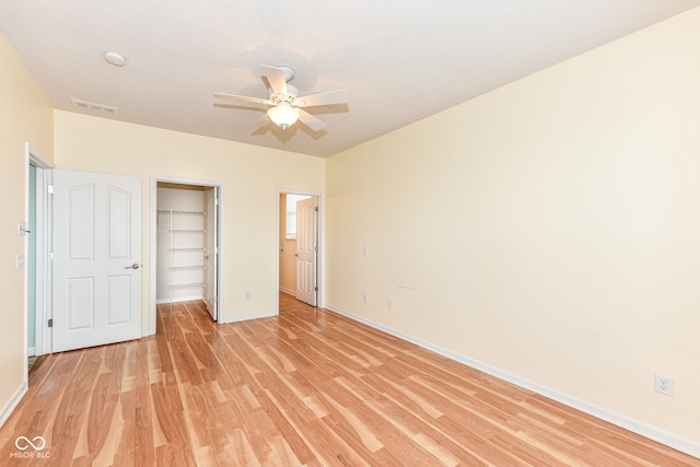 15946 Marsala Dr, Fishers, IN 46037 - unfurnished bedroom with light wood-style floors, a spacious closet, a closet, and a ceiling fan