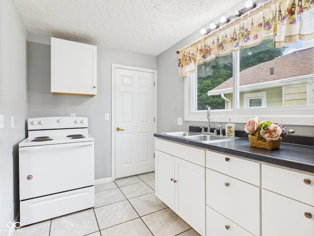 4025 Main St, Anderson, IN 46013 - kitchen with white range with electric stovetop, white cabinetry, light tile patterned floors, a textured ceiling, and dark countertops