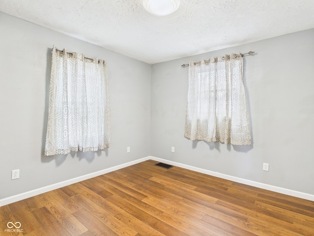 4025 Main St, Anderson, IN 46013 - unfurnished room with wood finished floors and a textured ceiling