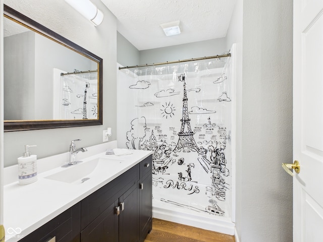 4025 Main St, Anderson, IN 46013 - full bathroom with vanity, wood finished floors, a textured ceiling, and a shower with curtain