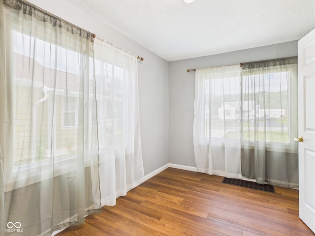 4025 Main St, Anderson, IN 46013 - empty room with wood finished floors and baseboards