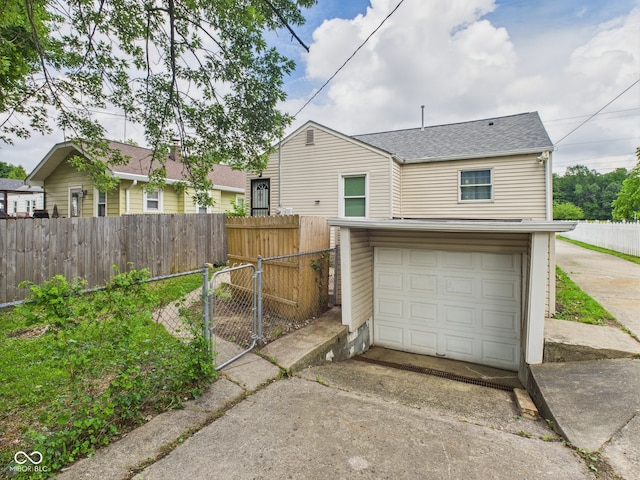 4025 Main St, Anderson, IN 46013 - garage with concrete driveway and a gate