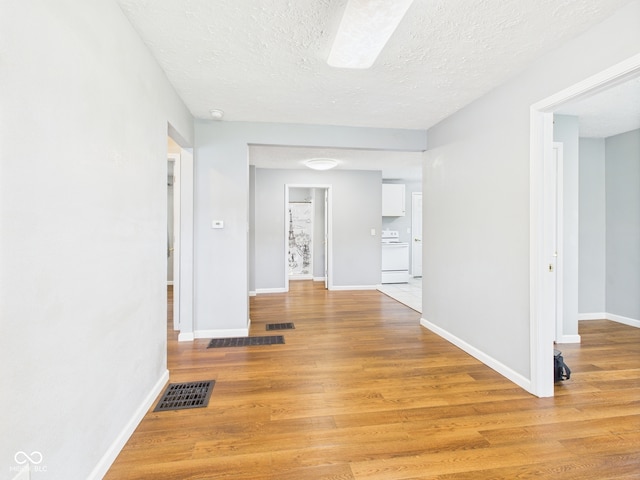 4025 Main St, Anderson, IN 46013 - hallway featuring light wood finished floors and a textured ceiling