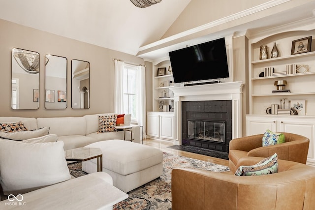 12505 Branford St, Carmel, IN 46032 - living room featuring lofted ceiling, a tiled fireplace, built in shelves, and light wood-type flooring