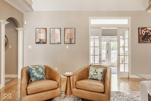 12505 Branford St, Carmel, IN 46032 - living area featuring decorative columns, wood finished floors, healthy amount of natural light, and french doors
