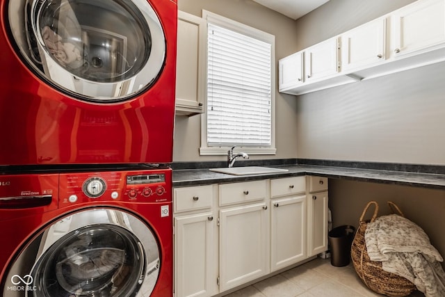 12505 Branford St, Carmel, IN 46032 - laundry area featuring stacked washer / dryer, cabinet space, and light tile patterned floors