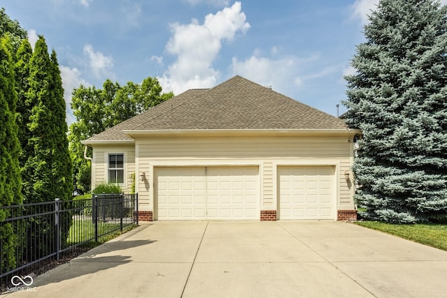 12505 Branford St, Carmel, IN 46032 - view of home's exterior featuring concrete driveway, an attached garage, a shingled roof, and brick siding