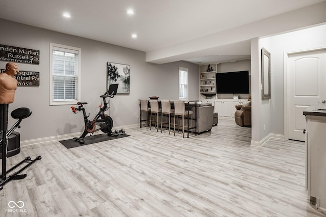 12505 Branford St, Carmel, IN 46032 - workout room featuring light wood-style flooring, recessed lighting, and a bar