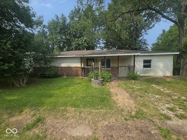 5156 N 14th St, Terre Haute, IN 47805 - view of front of house featuring covered porch, a front yard, and brick siding