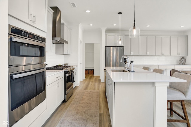 4250 Blackford Rd, Bargersville, IN 46106 - kitchen featuring stainless steel appliances, wall chimney exhaust hood, an island with sink, decorative backsplash, and a kitchen bar