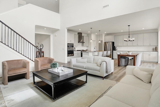 4250 Blackford Rd, Bargersville, IN 46106 - living area with light wood finished floors, a chandelier, recessed lighting, a towering ceiling, and stairway