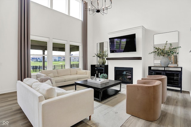 4250 Blackford Rd, Bargersville, IN 46106 - living area featuring a towering ceiling, a chandelier, plenty of natural light, and wood finished floors
