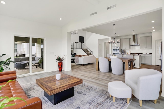 4250 Blackford Rd, Bargersville, IN 46106 - living room with light wood-style floors, a chandelier, stairway, recessed lighting, and high vaulted ceiling