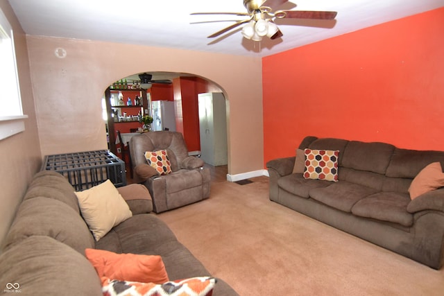 2616 Jackson St, Anderson, IN 46016 - living room featuring arched walkways, ceiling fan, and carpet flooring