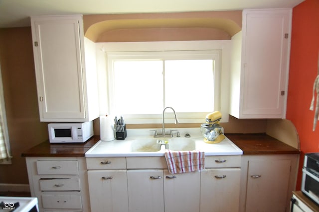 2616 Jackson St, Anderson, IN 46016 - kitchen featuring white microwave and white cabinetry