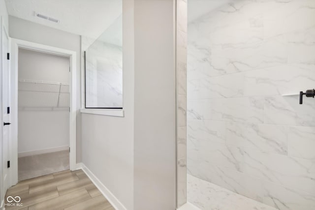 6842 Jacone Dr, Brownsburg, IN 46112 - bathroom with wood finished floors, a spacious closet, and a shower
