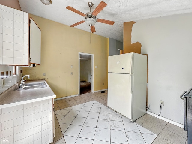 3251 Mars Hill St, Indianapolis, IN 46221 - kitchen featuring freestanding refrigerator, ceiling fan, light countertops, light tile patterned flooring, and a textured ceiling