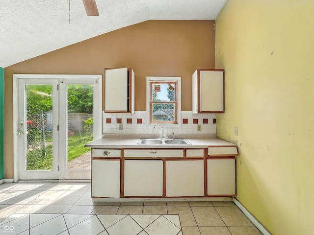 3251 Mars Hill St, Indianapolis, IN 46221 - kitchen featuring vaulted ceiling, light countertops, healthy amount of natural light, and light tile patterned floors
