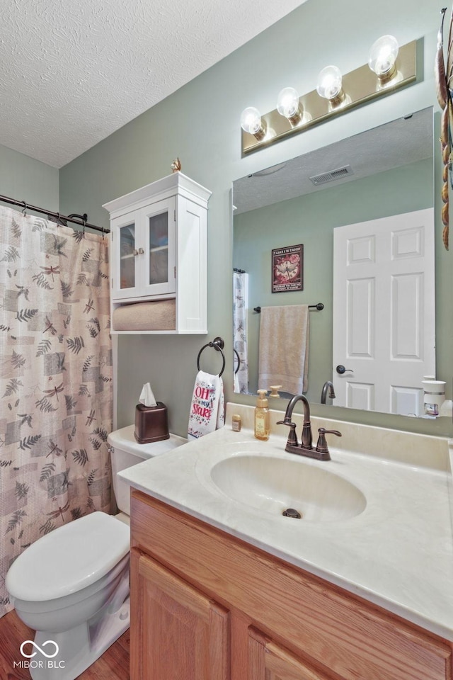 1896 Central Park Blvd W, Greenwood, IN 46143 - bathroom with vanity, wood finished floors, a textured ceiling, and a shower with shower curtain