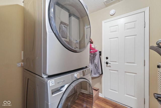 1896 Central Park Blvd W, Greenwood, IN 46143 - washroom with stacked washer / drying machine, wood finished floors, and a textured ceiling