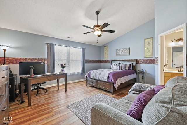 1896 Central Park Blvd W, Greenwood, IN 46143 - bedroom with lofted ceiling, a desk, wood finished floors, a textured ceiling, and ensuite bathroom