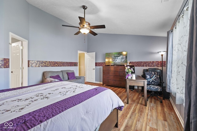 1896 Central Park Blvd W, Greenwood, IN 46143 - bedroom featuring vaulted ceiling, wood finished floors, wainscoting, and ceiling fan